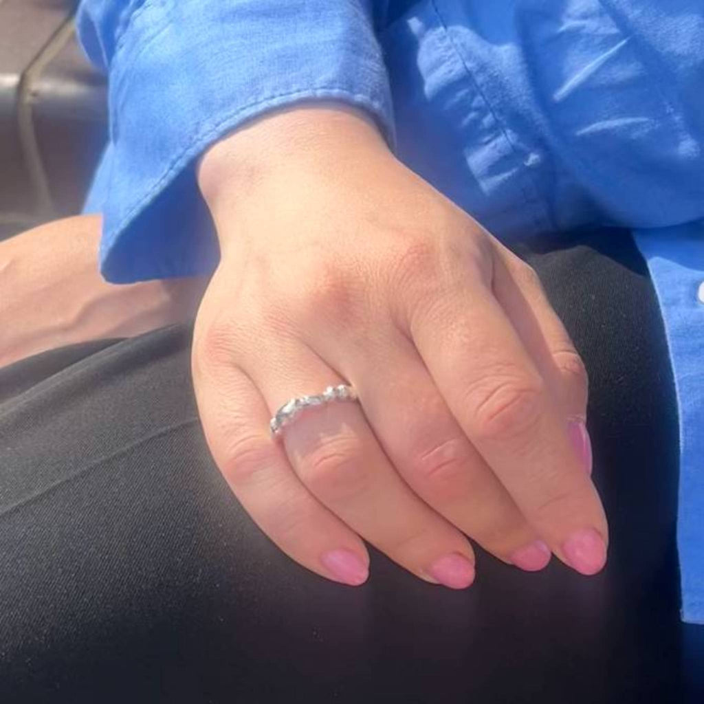 Aimless A sterling silver ring worn on hand showing delicate organic fluid texture
