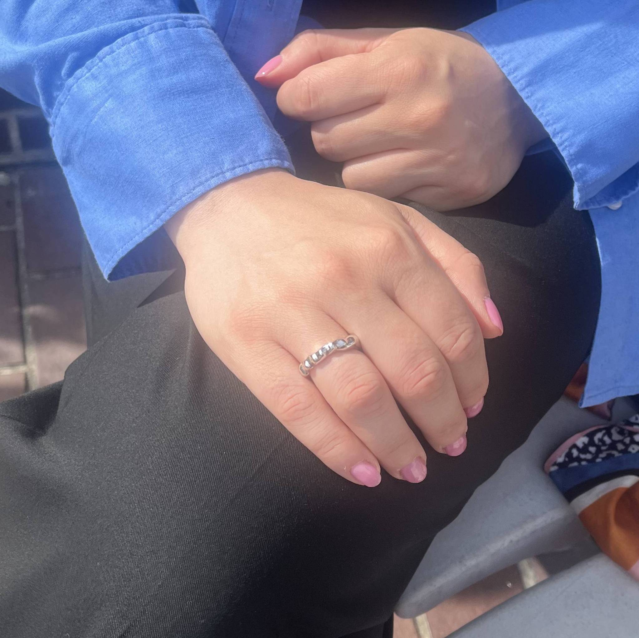 Aimless C sterling silver textured ring worn on hand showing fluid design