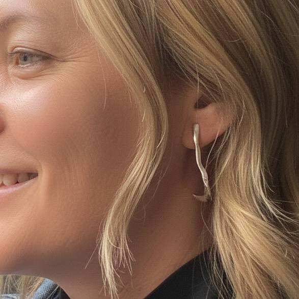 Aimless sterling silver long wave drop earrings styled on model showing elegant length