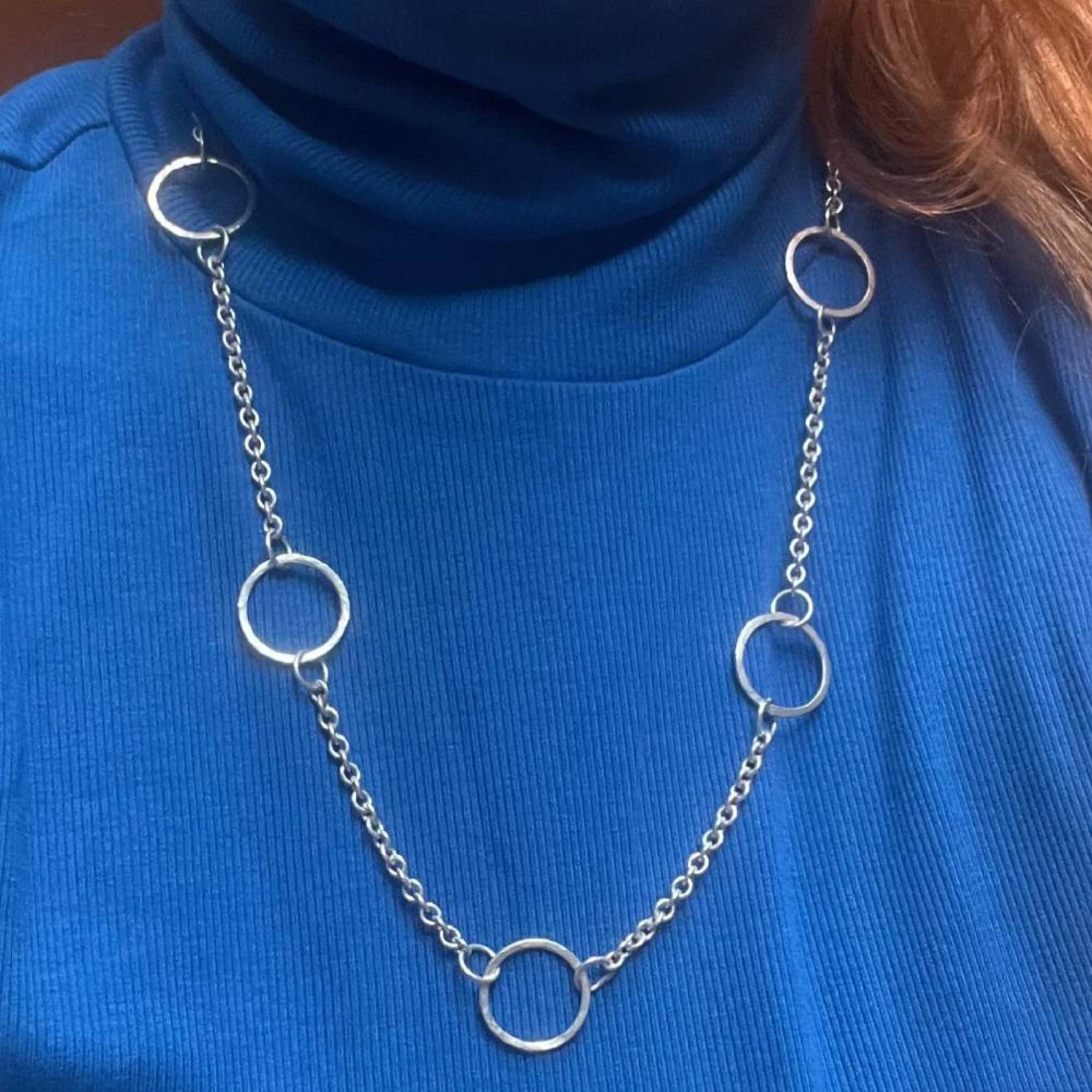 Chain of Hoops silver hoop necklace styled over a blue top showing full length and drape