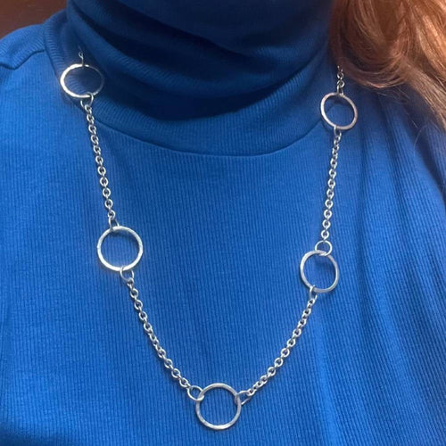 Chain of Hoops silver hoop necklace styled over a blue top showing full length and drape