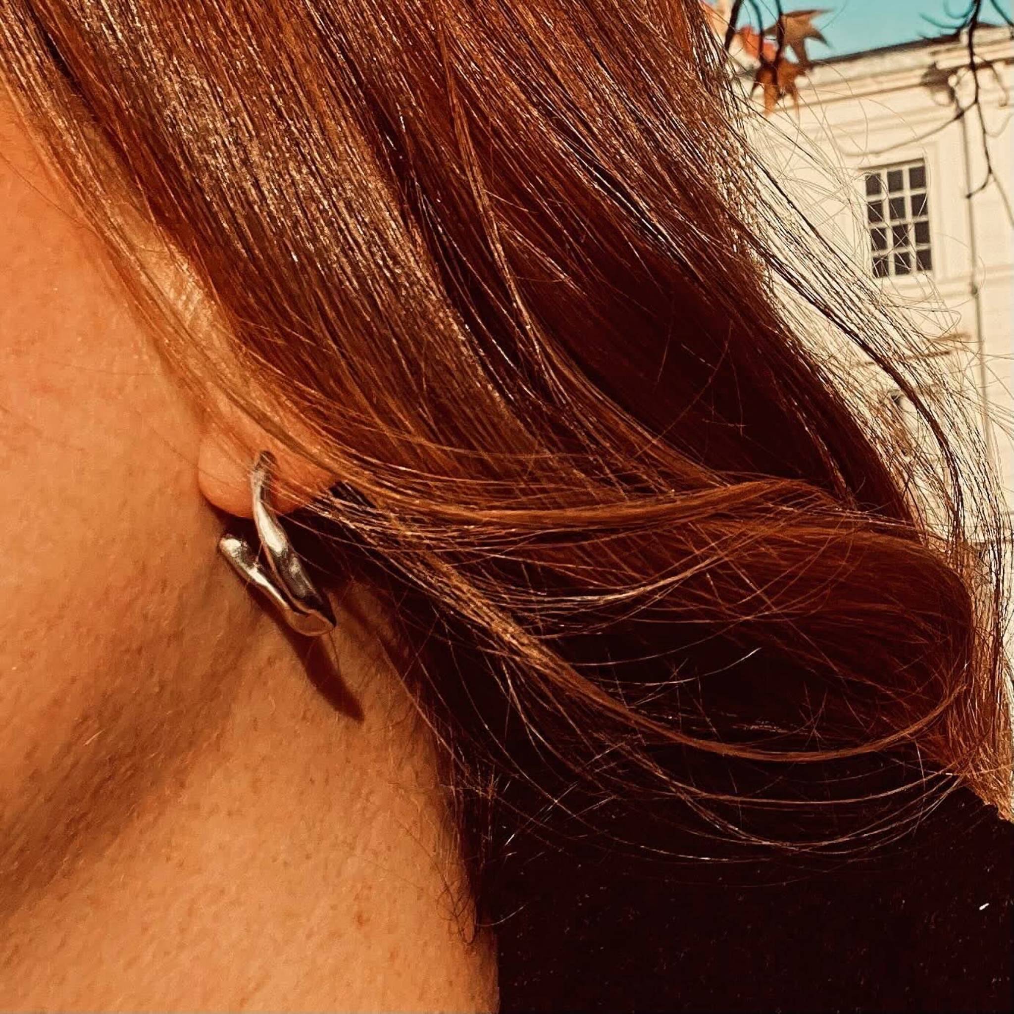 Recycled sterling silver twisted hoop earrings with polished finish