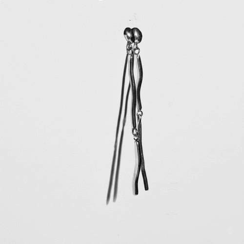 Flicker recycled sterling silver long drop earrings pair close up on neutral background