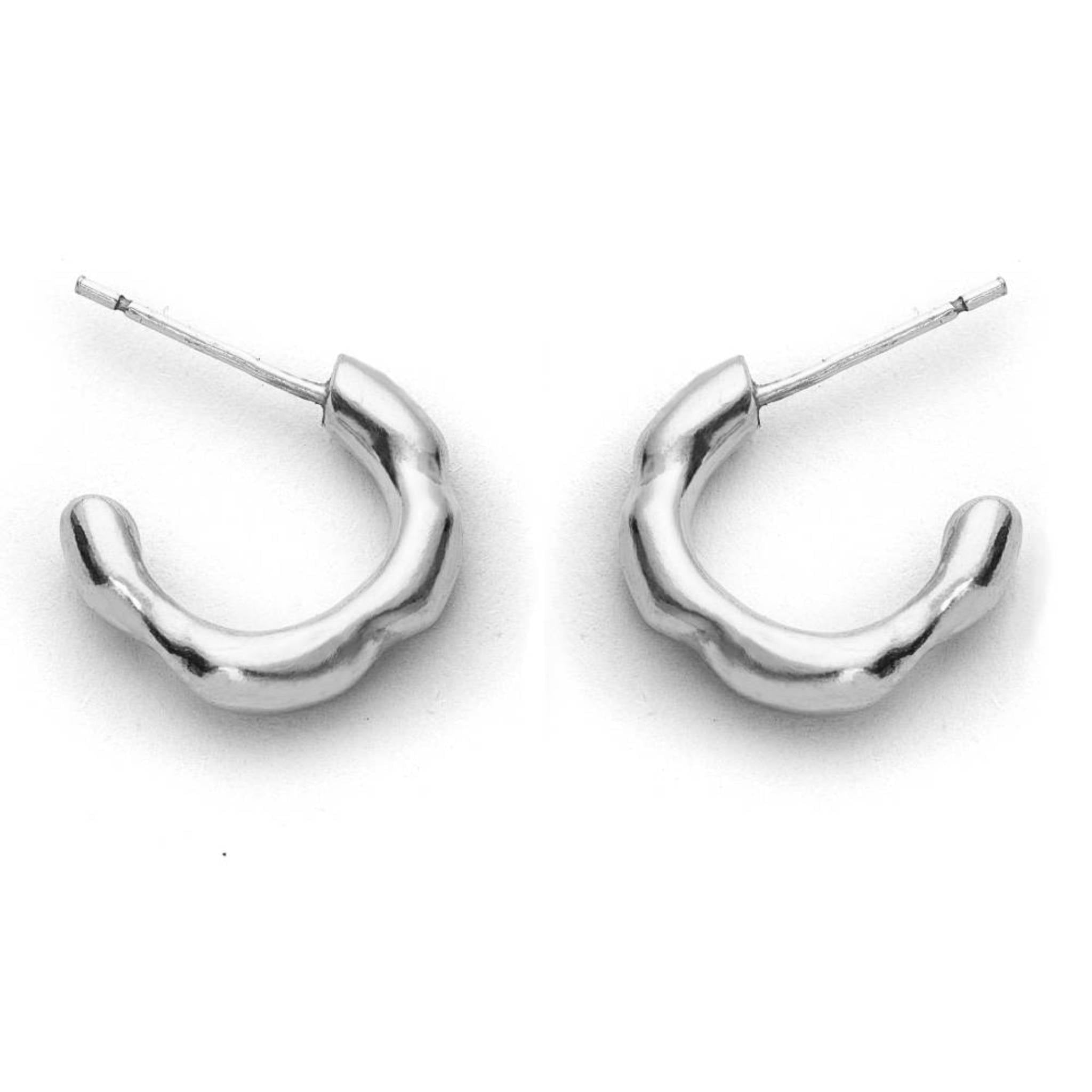 The Huggies recycled sterling silver small organic huggie hoop earrings pair close up on white background