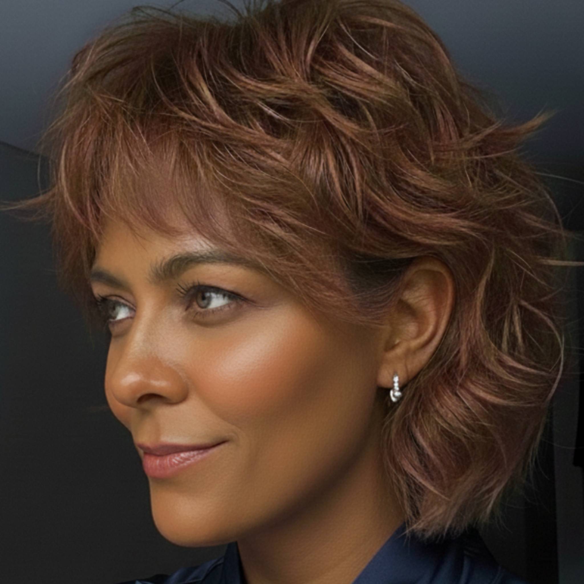 The Huggies sterling silver hoop earrings styled in ear stack on model showing petite fit