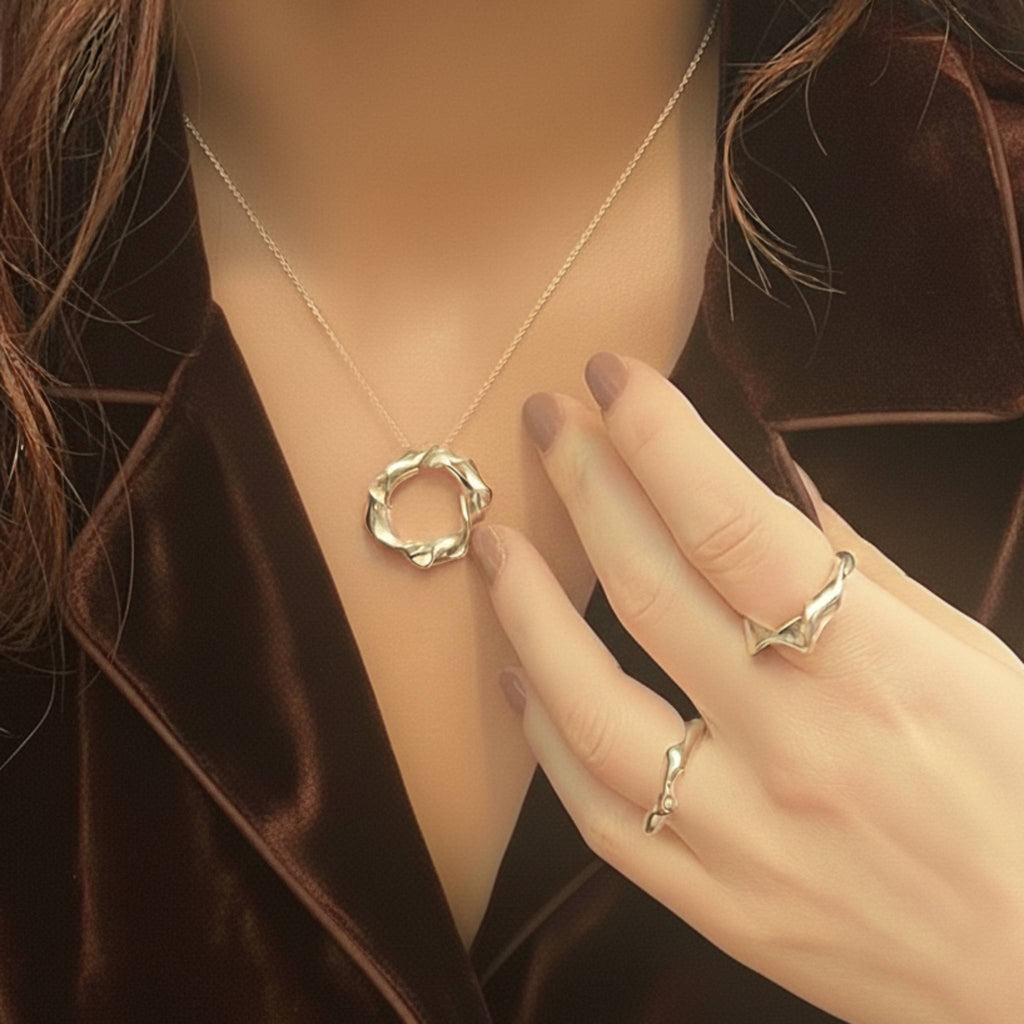 Twisted sterling silver circle pendant necklace styled on model showing neckline length and drape