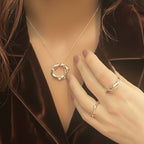 Twisted sterling silver circle pendant necklace styled on model showing neckline length and drape